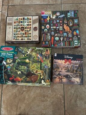 Assorted puzzles: 500 and 1000 Piece Jigsaw Puzzle Lot with Colorful Artwork.